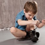 Kid tying his shoes