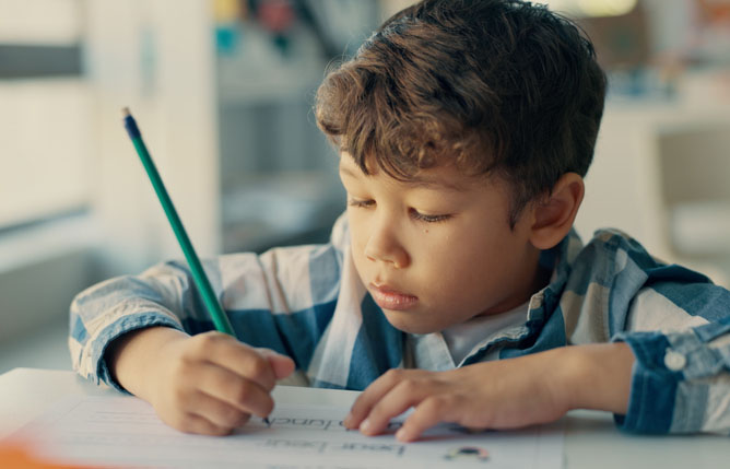 Child writing at his desk